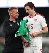 19 June 2023; Republic of Ireland chartered physiotherapist Danny Miller presents Louie Annesley of Gibraltar with a Republic of Ireland jersey after the UEFA EURO 2024 Championship qualifying group B match between Republic of Ireland and Gibraltar at the Aviva Stadium in Dublin. Photo by Michael P Ryan/Sportsfile