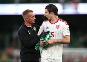 19 June 2023; Republic of Ireland chartered physiotherapist Danny Miller presents Louie Annesley of Gibraltar with a Republic of Ireland jersey after the UEFA EURO 2024 Championship qualifying group B match between Republic of Ireland and Gibraltar at the Aviva Stadium in Dublin. Photo by Michael P Ryan/Sportsfile