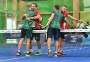 22 June 2023; Sean Neave of Ireland, left, and teammate Sam McKibbin embrace Marco Montanaro of Albania, second from left, and Fjoralb Curri after winning the men's double Padel qualification round match between Ireland and Albania during the European Games at the KSOS in Krakow. Photo by Tyler Miller/Sportsfile