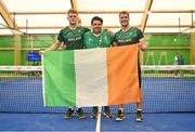 22 June 2023; Sean Neave of Ireland, left, and teammate Sam McKibbin, right, pose for a photograph with head coach Jeronimo Cañas and the tricolour after winning the men's double Padel qualification round match between Ireland and Albania during the European Games at the KSOS in Krakow. Photo by Tyler Miller/Sportsfile