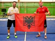 22 June 2023; Marco Montanaro of Albania, left, and teammate Fjoralb Curri pose for a photograph with the Albanian National flag after the men's double Padel qualification round match between Ireland and Albania during the European Games at the KSOS in Krakow. Photo by Tyler Miller/Sportsfile