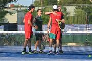 22 June 2023; Sam McKibbin of Ireland, second from left, and teammate Sean Neave, embrace Alfonso Fazendeiro of Portugal, left, and Miguel Oliveira after their loss in the men's double Padel Round of 16 match between Ireland and Portugal during the European Games at the KSOS in Krakow. Photo by Tyler Miller/Sportsfile