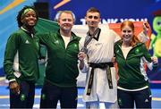23 June 2023; Jack Woolley of Ireland with his silver medal and, from left, teammate Leroy Dilandu, coach Robert Taaffe and team manager Niamh Buffini at the Krynica-Zdrój Arena during the European Games 2023 in Poland. Photo by David Fitzgerald/Sportsfile