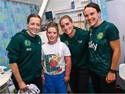 26 June 2023; Republic of Ireland players, from left, Harriet Scott, Chloe Mustaki and Ciara Grant, with Tony Moloney, age 10, from Windgap, Kilkenny, during a visit to Temple Street Children's Hospital in Dublin. Photo by Ramsey Cardy/Sportsfile