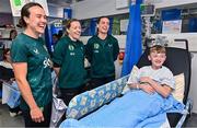 26 June 2023; Republic of Ireland players, from left, Ciara Grant, Harriet Scott and Chloe Mustaki, with Zach Humston, age 15, from Dundalk, Louth, during a visit to Temple Street Children's Hospital in Dublin. Photo by Ramsey Cardy/Sportsfile