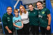 26 June 2023; Republic of Ireland players, from left, Chloe Mustaki, Harriet Scott and Ciara Grant, with Jordan Ryan, age 9, and his mum Rachel, from Balbriggan, Dublin, during a visit to Temple Street Children's Hospital in Dublin. Photo by Ramsey Cardy/Sportsfile