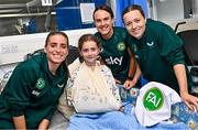 26 June 2023; Republic of Ireland players, from left, Ciara Grant, Harriet Scott and Chloe Mustaki, with Sarah Weston, age 9, from Ashbourne, Meath, during a visit to Temple Street Children's Hospital in Dublin. Photo by Ramsey Cardy/Sportsfile