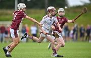 24 June 2023; Joey McMahon of St Mary's Athenry, Galway, in action against Zach Donegan, left, and Marc Dempsey of Raheny, Dublin, during the John West Féile na nGael National Camogie and Hurling Finals 2023 at the Connacht GAA Centre in Bekan, Mayo. Eighty club sides took part in the national finals across seven venues in Connacht. Sponsored for the eighth time by John West, it is one of the biggest underage sporting events on the continent. Photo by Sam Barnes/Sportsfile