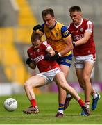24 June 2023; Matty Taylor of Cork is tackled by Enda Smith of Roscommon as team-mate Tommy Walsh of Cork watches on during the GAA Football All-Ireland Senior Championship Preliminary Quarter Final match between Cork and Roscommon at Páirc Uí Chaoimh in Cork. Photo by Tom Beary/Sportsfile
