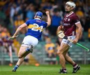 24 June 2023; John McGrath of Tipperary celebrates after scoring his side's first goal as Daithí Burke of Galway looks on during the GAA Hurling All-Ireland Senior Championship Quarter Final match between Galway and Tipperary at TUS Gaelic Grounds in Limerick. Photo by Piaras Ó Mídheach/Sportsfile