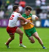 24 June 2023; Odhran Doherty of Donegal is tackled by Kieran McGeary of Tyrone during the GAA Football All-Ireland Senior Championship Preliminary Quarter Final match between Donegal and Tyrone at MacCumhaill Park in Ballybofey, Donegal. Photo by Brendan Moran/Sportsfile