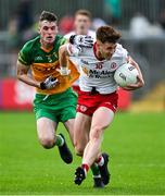 24 June 2023; Conor Meyler of Tyrone is tackled by Caolan Ward of Donegal during the GAA Football All-Ireland Senior Championship Preliminary Quarter Final match between Donegal and Tyrone at MacCumhaill Park in Ballybofey, Donegal. Photo by Brendan Moran/Sportsfile