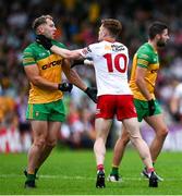 24 June 2023; Odhran Doherty of Donegal, left, and Conor Meyler of Tyrone get into a tussle during the GAA Football All-Ireland Senior Championship Preliminary Quarter Final match between Donegal and Tyrone at MacCumhaill Park in Ballybofey, Donegal. Photo by Brendan Moran/Sportsfile