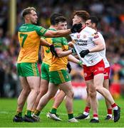 24 June 2023; Odhran Doherty of Donegal, left, and Conor Meyler of Tyrone get into a tussle during the GAA Football All-Ireland Senior Championship Preliminary Quarter Final match between Donegal and Tyrone at MacCumhaill Park in Ballybofey, Donegal. Photo by Brendan Moran/Sportsfile