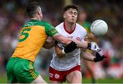 24 June 2023; Conor Meyler of Tyrone is tackled by Caolan Ward of Donegal during the GAA Football All-Ireland Senior Championship Preliminary Quarter Final match between Donegal and Tyrone at MacCumhaill Park in Ballybofey, Donegal. Photo by Brendan Moran/Sportsfile