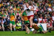 24 June 2023; Conn Kilpatrick of Tyrone beats the tackle of Brian O'Donnell of Donegal during the GAA Football All-Ireland Senior Championship Preliminary Quarter Final match between Donegal and Tyrone at MacCumhaill Park in Ballybofey, Donegal. Photo by Brendan Moran/Sportsfile