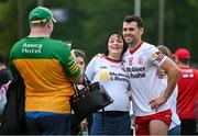 24 June 2023; Tyrone supporter Cathy Gallen has her photo taken with Darren McCurry of Tyrone by Donegal supporter Adrian Connolly after the GAA Football All-Ireland Senior Championship Preliminary Quarter Final match between Donegal and Tyrone at MacCumhaill Park in Ballybofey, Donegal. Photo by Brendan Moran/Sportsfile