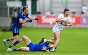 24 June 2023; Shea Ryan of Kildare evades the tackle of Monaghan's Killian Lavelle and Jack McCarron during the GAA Football All-Ireland Senior Championship Preliminary Quarter Final match between Kildare and Monaghan at Glenisk O'Connor Park in Tullamore, Offaly. Photo by Seb Daly/Sportsfile