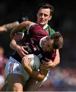 25 June 2023; Paul Conroy of Galway is tackled by Diarmuid O'Connor of Mayo during the GAA Football All-Ireland Senior Championship Preliminary Quarter Final match between Galway and Mayo at Pearse Stadium in Galway. Photo by Brendan Moran/Sportsfile