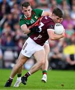 25 June 2023; Cathal Sweeney of Galway is tackled by Eoghan McLaughlin of Mayo during the GAA Football All-Ireland Senior Championship Preliminary Quarter Final match between Galway and Mayo at Pearse Stadium in Galway. Photo by Brendan Moran/Sportsfile