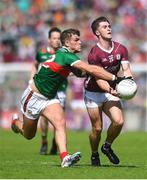 25 June 2023; Cathal Sweeney of Galway in action against Jordan Flynn of Mayo  during the GAA Football All-Ireland Senior Championship Preliminary Quarter Final match between Galway and Mayo at Pearse Stadium in Galway. Photo by John Sheridan/Sportsfile