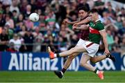 25 June 2023; James Carr of Mayo kicks his side's last point despite the efforts of Seán Kelly of Galway during the GAA Football All-Ireland Senior Championship Preliminary Quarter Final match between Galway and Mayo at Pearse Stadium in Galway. Photo by Brendan Moran/Sportsfile