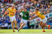 25 June 2023; James McEntee of Meath in action against Antrim players Marc Jordan, left, and Joseph Finnegan during the Tailteann Cup Semi Final match between Antrim and Meath at Croke Park in Dublin. Photo by Michael P Ryan/Sportsfile