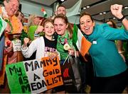 26 June 2023; Team Ireland's Lauren Campbell, a member of Palmerstown Wildcats Special Olympics Club, from Dublin 12, is welcomed by her daughter Ava, aged 9, left, and Aer Lingus Cabin crew member Paloma O'Reilly, right, at Dublin Airport on the team's return from the World Special Olympic Games in Berlin, Germany. Photo by Sam Barnes/Sportsfile