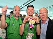 26 June 2023; Team Ireland's Timothy Morahan, a member of South Dublin Sports Club, from Dublin 6, with his coach Paddy Slattery, left, and father John Morahan, right, at Dublin Airport on the team's return from the World Special Olympic Games in Berlin, Germany. Photo by Sam Barnes/Sportsfile