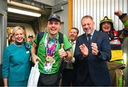 26 June 2023; Team Ireland's Timothy Morahan, a member of South Dublin Sports Club, from Dublin 6, is greeted by Minister of State at Department of Tourism, Culture, Arts, Gaeltacht, Sport and Media Thomas Byrne TD and Kelly Grant, Senior Cabin Crew, Aer Lingus, at Dublin Airport on the team's return from the World Special Olympic Games in Berlin, Germany. Photo by Ray McManus/Sportsfile