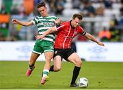 26 June 2023; Cameron McJannet of Derry City in action against Johnny Kenny of Shamrock Rovers during the SSE Airtricity Men's Premier Division match between Shamrock Rovers and Derry City at Tallaght Stadium in Dublin. Photo by Stephen McCarthy/Sportsfile