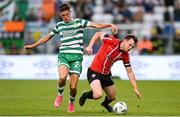 26 June 2023; Cameron McJannet of Derry City in action against Johnny Kenny of Shamrock Rovers during the SSE Airtricity Men's Premier Division match between Shamrock Rovers and Derry City at Tallaght Stadium in Dublin. Photo by Stephen McCarthy/Sportsfile