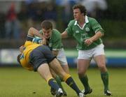 23 June 2004; Drew Mitchell, Australia, is tackled by Ireland's John Hearty and Paul McKenzie, right. IRB Under 21 World Rugby Championship, Semi-Final, Ireland v Australia, Hughenden, Glasgow, Scotland. Picture credit; Brian Lawless / SPORTSFILE