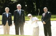 25 June 2004; Ita Butler, left, President of the Irish Ladies Golfing Union of Ireland, with Dick Cusack, second from left, Golfing Union of Ireland, and Jim Kelly, AIB, watch on as Cian Poland, aged 12 from Dublin, takes a shot from the bunker at the launch of the AIB Golf Club of the Year Awards 2004. Elm Park Golf Club, Dublin. Picture credit; David Maher / SPORTSFILE