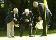 25 June 2004; Ita Butler, President of the Irish Ladies Golfing Union of Ireland, and Dick Cusack, centre, Golfing Union of Ireland, line up a putt for Jim Kelly, AIB, at the launch of the AIB Golf Club of the Year Awards 2004. Elm Park Golf Club, Dublin. Picture credit; David Maher / SPORTSFILE