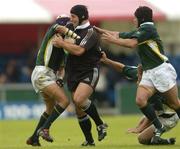 23 June 2004; Luke McAllister, New Zealand, in action against South Africa's Earl Rose, left, Derick Hougaard (black skull cap) and Wynand Olivier. IRB Under 21 World Rugby Championship, Semi-Final, New Zealand v South Africa, Hughenden, Glasgow, Scotland. Picture credit; Brian Lawless / SPORTSFILE