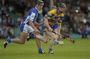 26 June 2004; Niall Gilligan, Clare, is tackled by Darren Rooney, Laois. Guinness Senior Hurling Championship Qualifier, Round 1, Clare v Laois, Gaelic Grounds, Limerick. Picture credit; Pat Murphy / SPORTSFILE