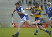 26 June 2004; Cyril Cuddy, Laois, is tackled by Daithi O'Connell, Clare. Guinness Senior Hurling Championship Qualifier, Round 1, Clare v Laois, Gaelic Grounds, Limerick. Picture credit; Pat Murphy / SPORTSFILE