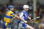 26 June 2004; Tommy Fitzgeraly, Laois, is tackled by Gerry O'Grady, Clare. Guinness Senior Hurling Championship Qualifier, Round 1, Clare v Laois, Gaelic Grounds, Limerick. Picture credit; Ray McManus / SPORTSFILE