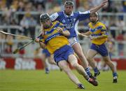 26 June 2004; Frank Lohan, Clare, is tackled by Joe Fitzpatrick, Laois. Guinness Senior Hurling Championship Qualifier, Round 1, Clare v Laois, Gaelic Grounds, Limerick. Picture credit; Pat Murphy / SPORTSFILE