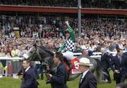 27 June 2004; Pat Smullen celebrates winning the  Budweiser Irish Derby on Grey Swallow as he makes his way past the main stand. Curragh Racecourse, Co. Kildare. Picture credit; Matt Browne / SPORTSFILE