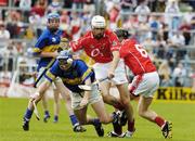27 June 2004; Shane Long, Tipperary, is tackled by Patrick Cronin, left, and Padraig Cotter, Cork. Munster Minor Hurling Championship Final, Cork v Tipperary, Semple Stadium, Thurles, Co. Tipperary. Picture credit; Pat Murphy / SPORTSFILE