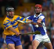 26 June 2004; Tony Carmody, Clare, in action against James Young, Laois. Guinness Senior Hurling Championship Qualifier, Round 1, Clare v Laois, Gaelic Grounds, Limerick. Picture credit; Ray McManus / SPORTSFILE