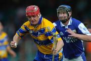 26 June 2004; Brian Lohan, Clare, prepares to clear under pressure from Damien Walsh, Laois. Guinness Senior Hurling Championship Qualifier, Round 1, Clare v Laois, Gaelic Grounds, Limerick. Picture credit; Ray McManus / SPORTSFILE