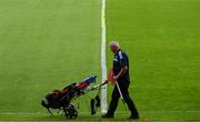 24 June 2023; A member of the grounds staff places flags around the ground before the GAA Hurling All-Ireland Senior Championship Quarter Final match between Clare and Dublin at TUS Gaelic Grounds in Limerick. Photo by Ray McManus/Sportsfile