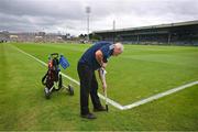 24 June 2023; A member of the grounds staff places flags around the ground before the GAA Hurling All-Ireland Senior Championship Quarter Final match between Clare and Dublin at TUS Gaelic Grounds in Limerick. Photo by Ray McManus/Sportsfile