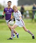 1 July 2023; Senan McDonnell of St. Mary's Athenry in action against Rory Flannery of Kilmacud Crokes during the John West Féile Peile na nÓg Finals 2023 at the Connacht GAA Centre of Excellence in Bekan, Mayo. Photo by Stephen Marken/Sportsfile