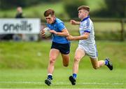 1 July 2023; Fionn Ó Cinnseala of Westport in action against Aran Martin of Naas during the John West Féile Peile na nÓg Finals 2023 at the Connacht GAA Centre of Excellence in Bekan, Mayo. Photo by Stephen Marken/Sportsfile
