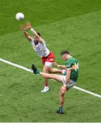 1 July 2023; David Clifford of Kerry kicks a point despite the efforts of Pádraig Hampsey of Tyrone during the GAA Football All-Ireland Senior Championship quarter-final match between Kerry and Tyrone at Croke Park in Dublin. Photo by Brendan Moran/Sportsfile