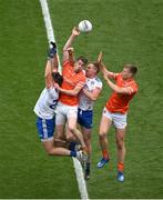 1 July 2023; Andrew Murnin, second from left, and Rian O'Neill of Armagh contest a kickout with Darren Hughes, left, and Kieran Duffy of Monaghan during the GAA Football All-Ireland Senior Championship quarter-final match between Armagh and Monaghan at Croke Park in Dublin. Photo by Brendan Moran/Sportsfile